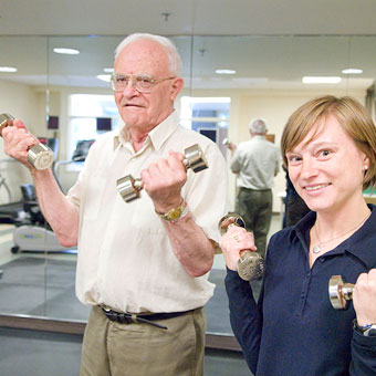 Elder male lifting weights at the Herbst Fitness Center at the Jewish Home