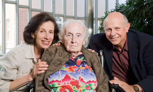 Older woman with adult children in the lobby of the Rosenberg Family Center