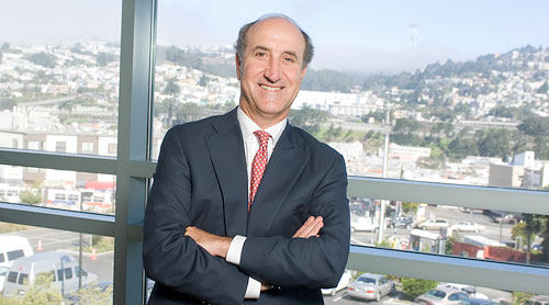 Mark Myers in front of window overlooking San Francisco