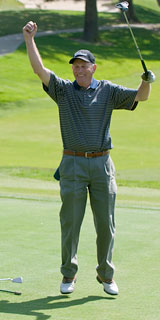 Man on the green, jumping with excitement
