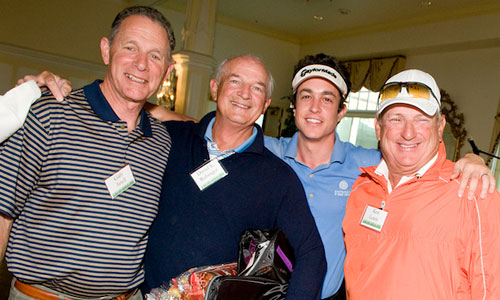 Four males posing as winners