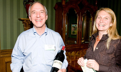 Husband and wife with bottle of wine