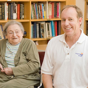 Young woman cheek-to-cheek with female resident