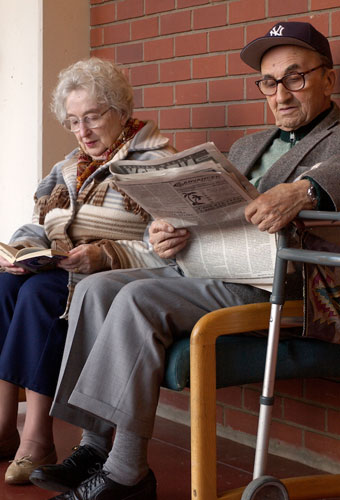 Two elders reading in the galleria at the Jewish Home