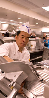 Guests get a tour of the new kitchen, while employee uses equipment