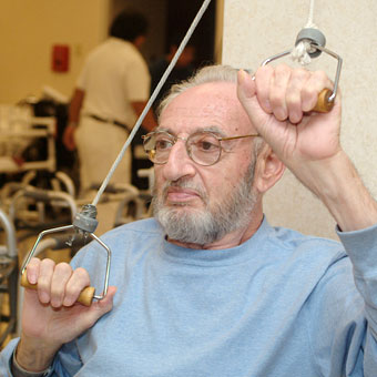 Resident using pullies in Physical Therapy