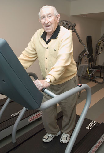 resident using treadmill in the fitness center
