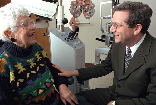 Dr. Jay Luxenberg with resident in the Optometry clinic