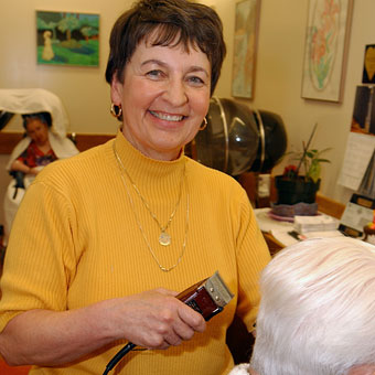Employee cutting hair in beauty shop